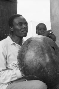 Sekuru Chigamba plays mbira as his grandchildren Augustine Basa and Gerald Basa listen