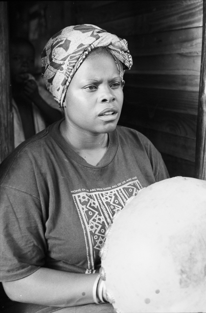 Irene Chigamba plays mbira in the doorway of her home